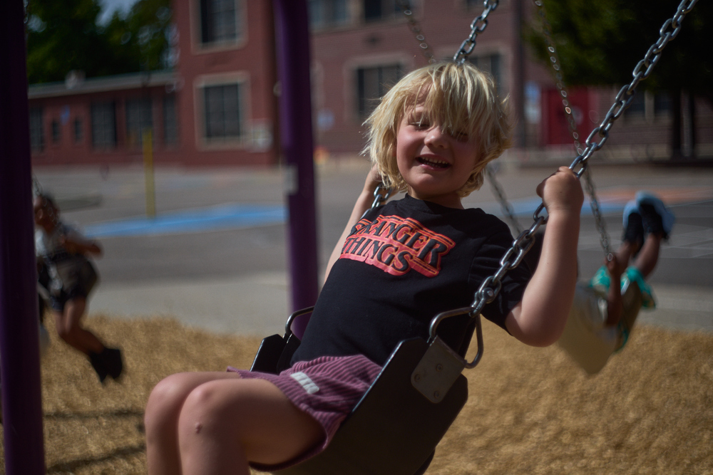 CAUCASIAN STUDENT ON SWING
