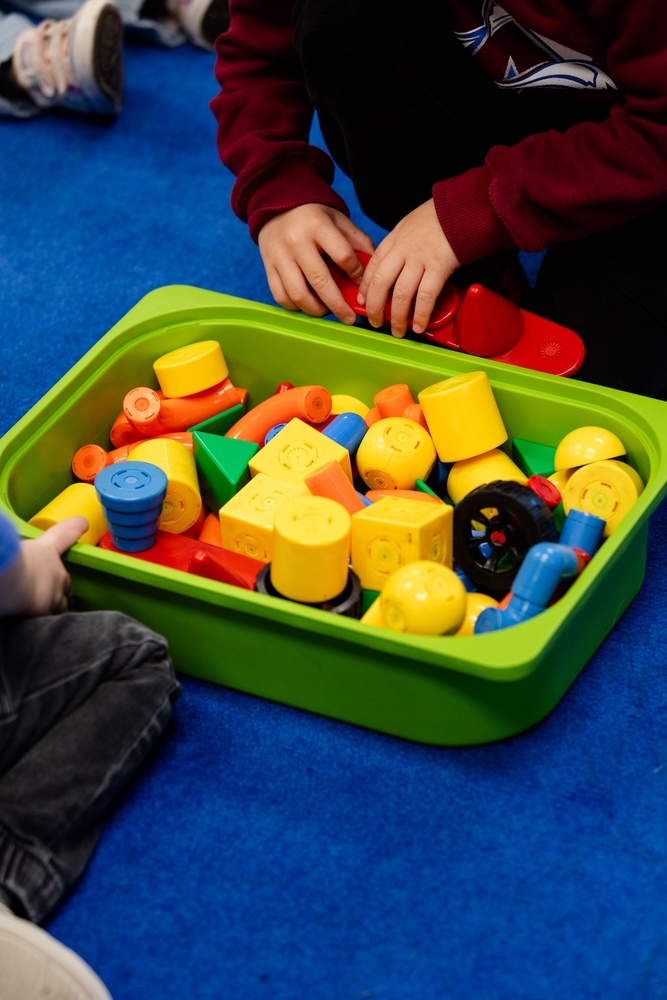 students playing with blocks in a bin