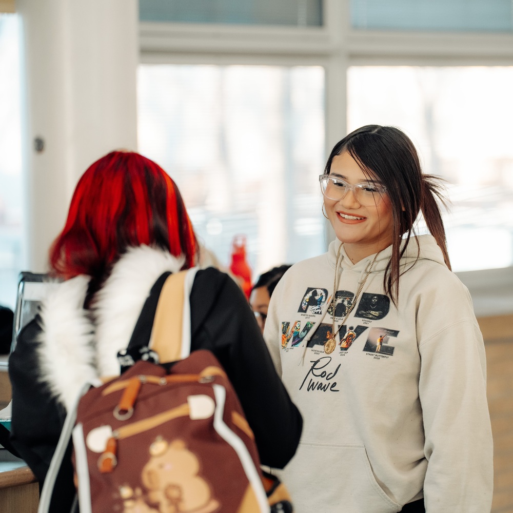 Photo Image of 2 Female CEC students enaging in conversation in the hallway