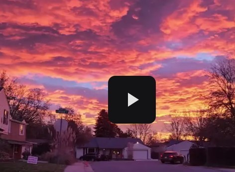 pink sunset with a play button 