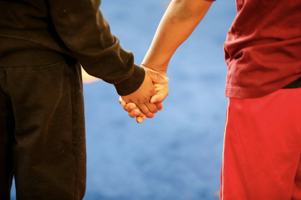 Two people holding hands