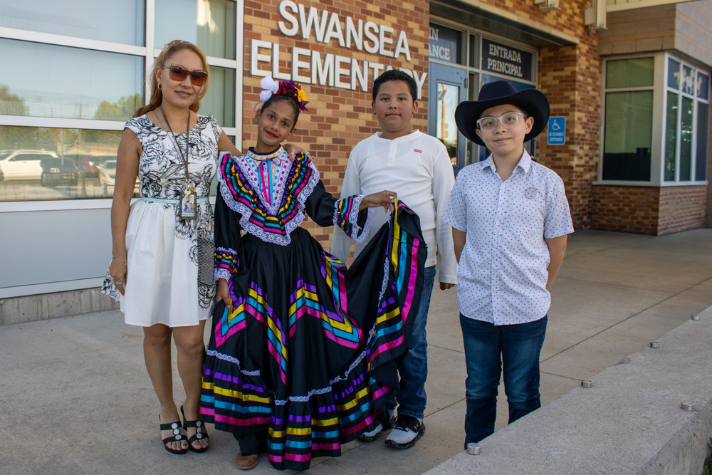 Ms. Babb takes a photo with her students ahead of their performance at Fiesta Hispana.