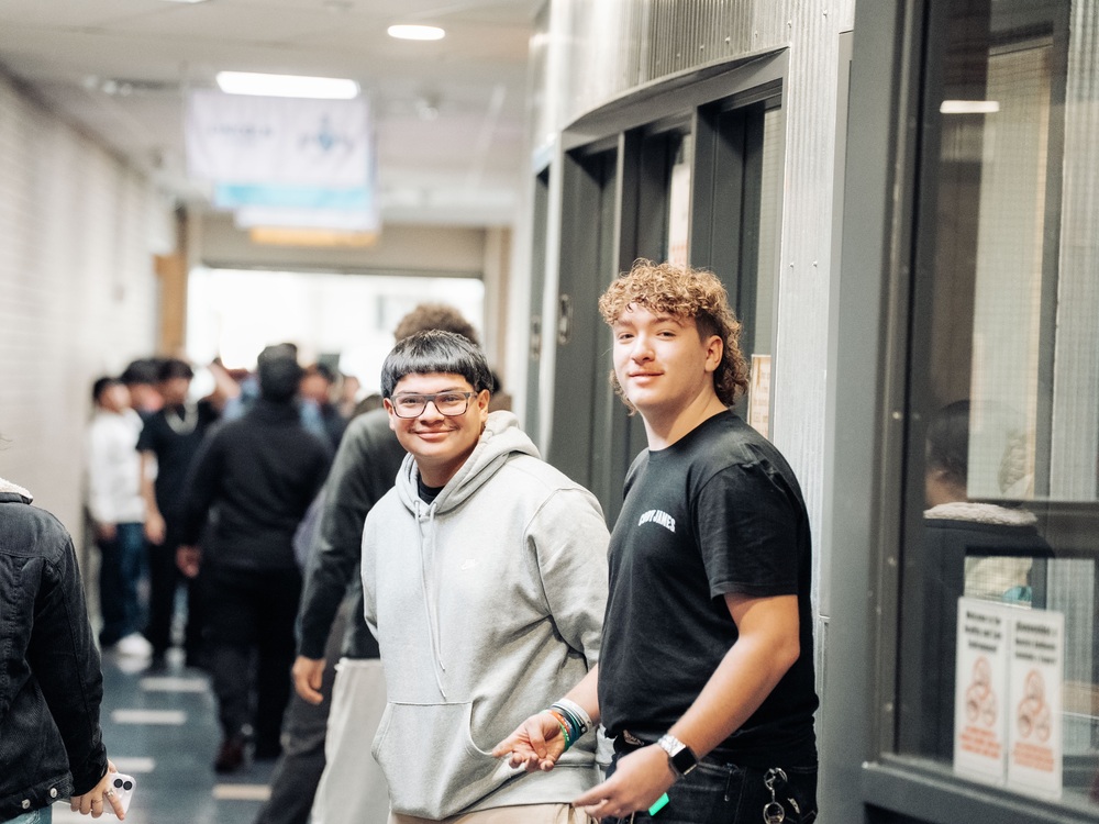 2 male high schoolers standing in the hallway during passing period at CEC Early College