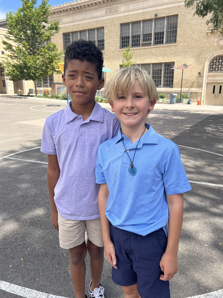 2 boys standing on a playground