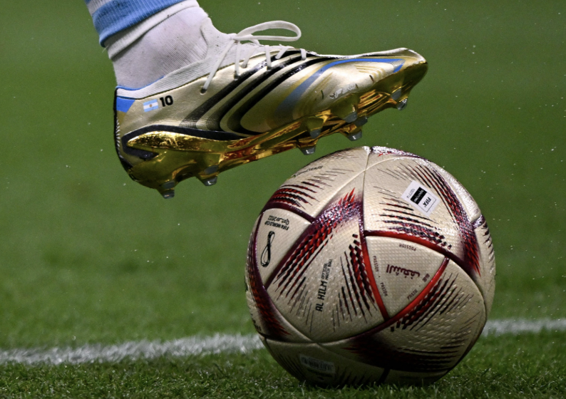 Cleated foot and soccer ball