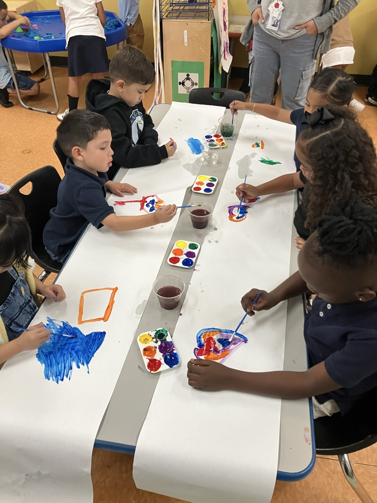 room 113 working in their mural 