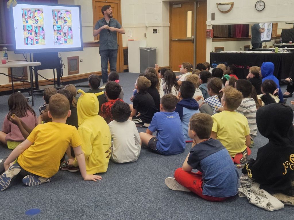 Mat Heagerty speaking to a group of children