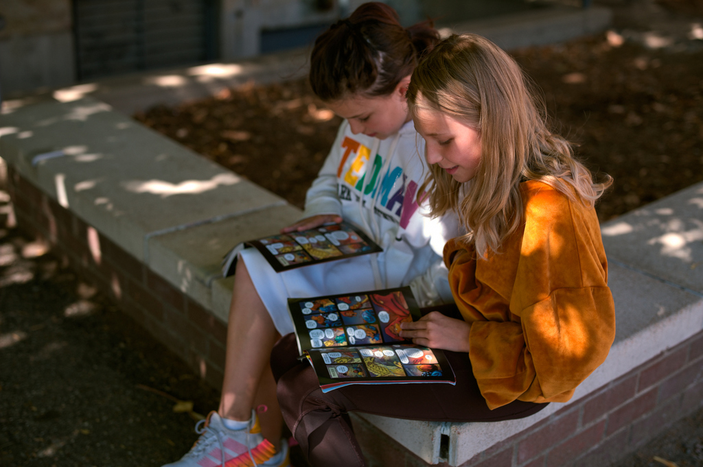 2 FEMALE STUDENTS READING.