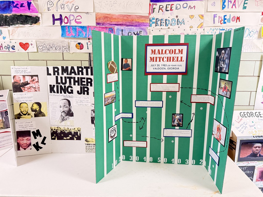 Student posters about the lives of MLK Jr and Malcolm Mitchell.