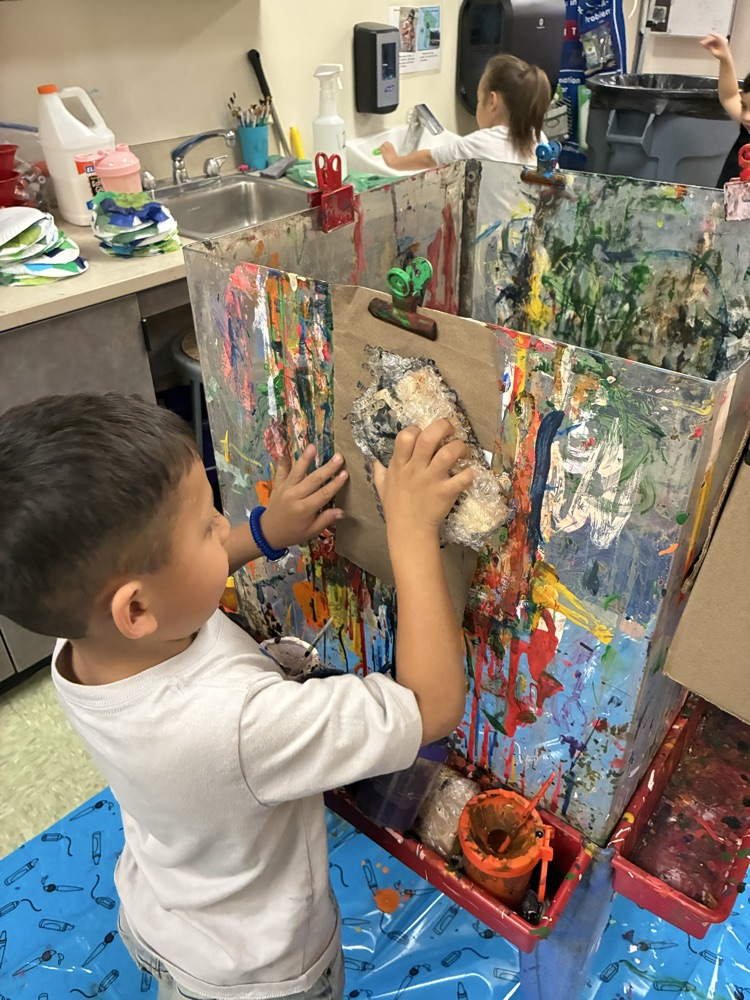 students painted on blocks wrapped in bubble wrap and printed it on recycled materials