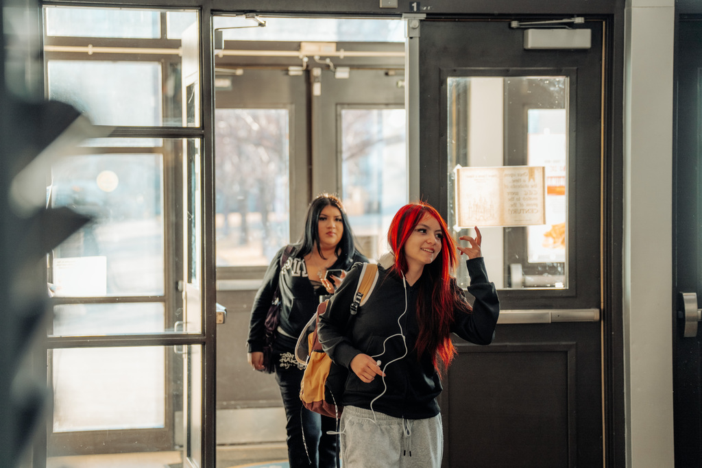 Two females students entering the main entrance at CEC Early College