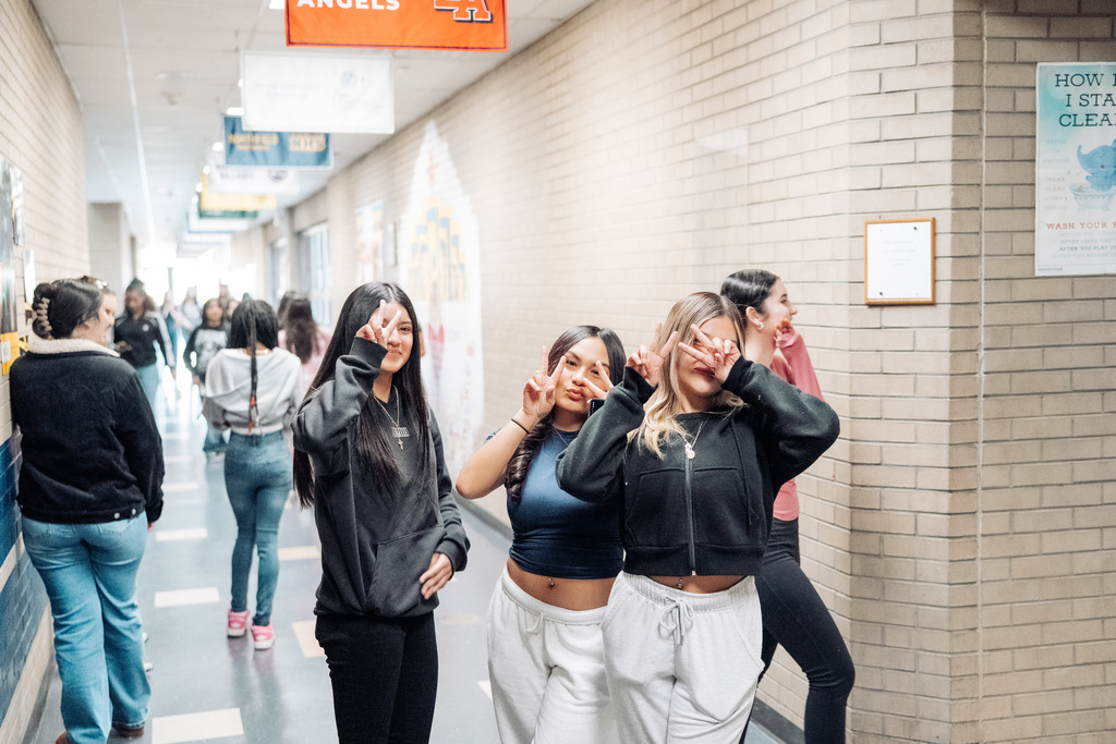 Three females students in the hallways during passing period  at CEC Early College