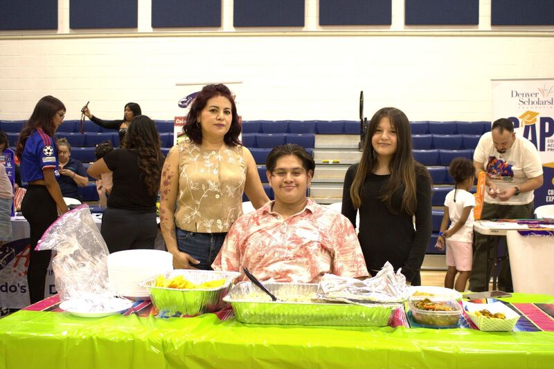 Family poses with their potluck items