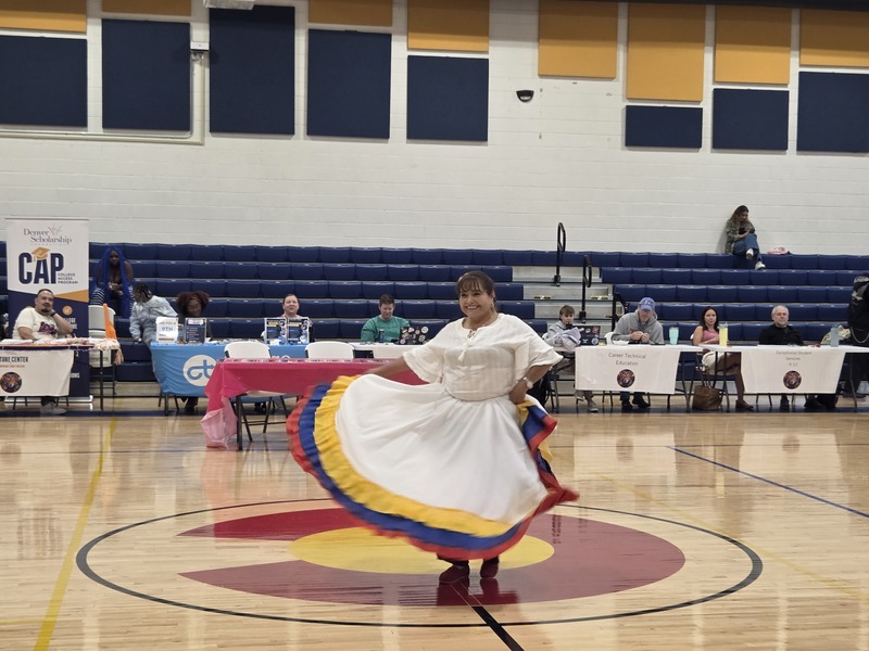 NEC staff spins in her dress