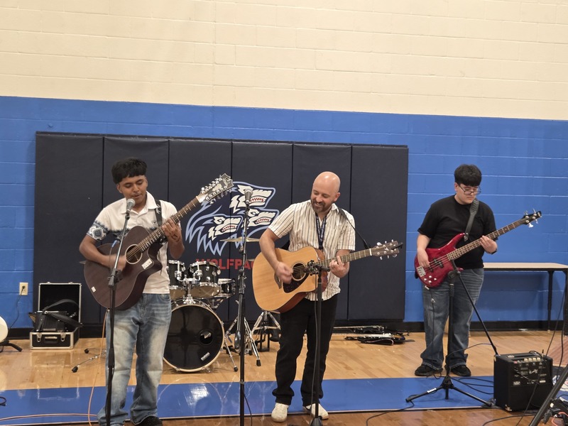 NEC students and staff play guitars and sing