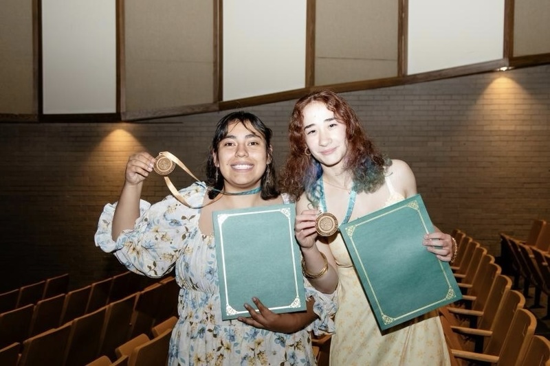 Two students holding Climate Literacy medals