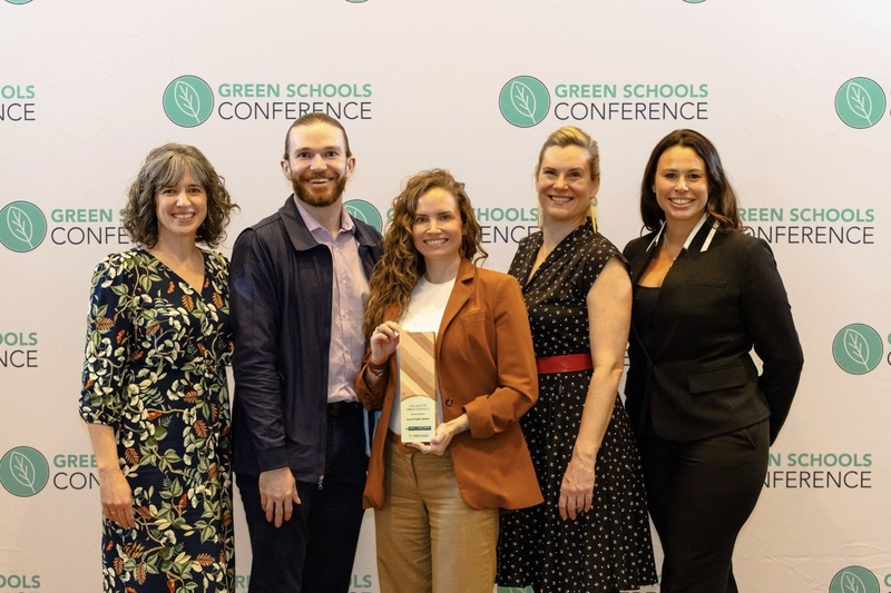 Group of people posing with award trophy