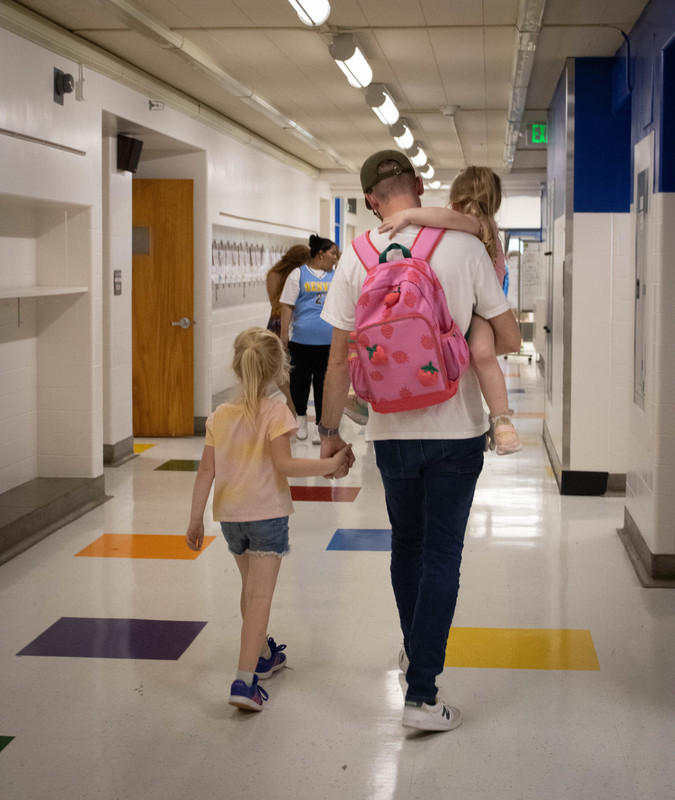McMeen family walks through the hallway.
