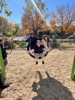 students on swing equipment