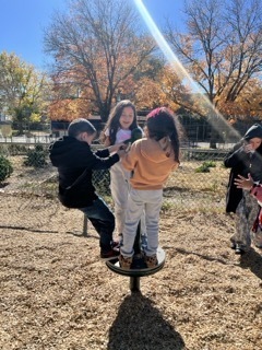 students on spinning equipment