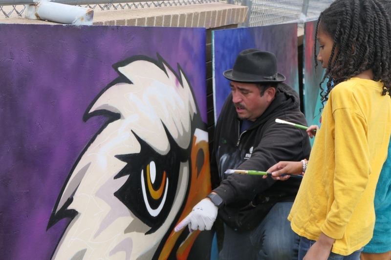 Person pointing at detail on mural