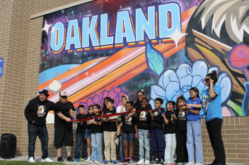 Group of students standing in front of mural