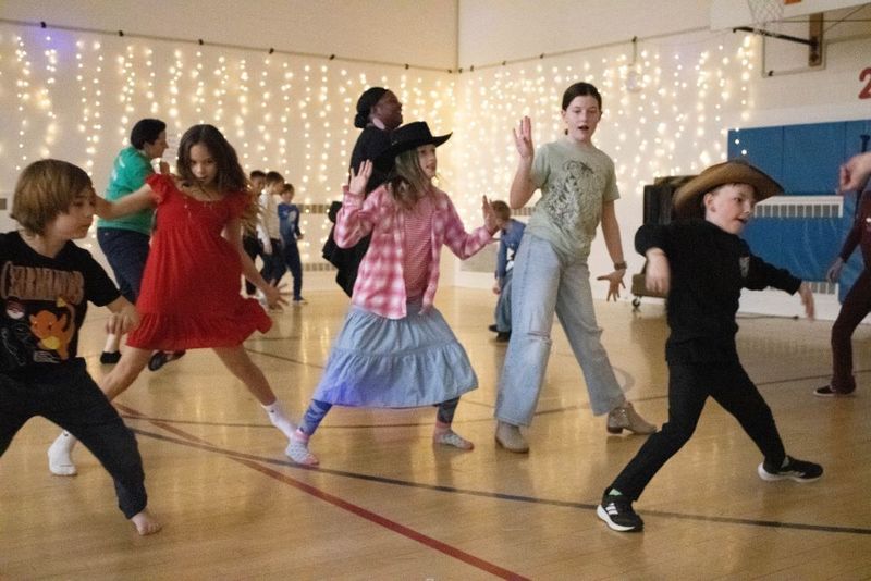 Students dancing in the gym decorated in pretty lights
