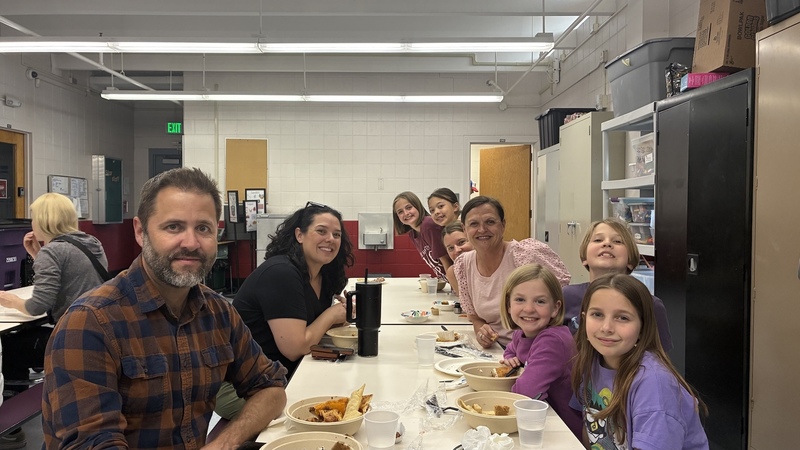 Group of people sitting at a long table