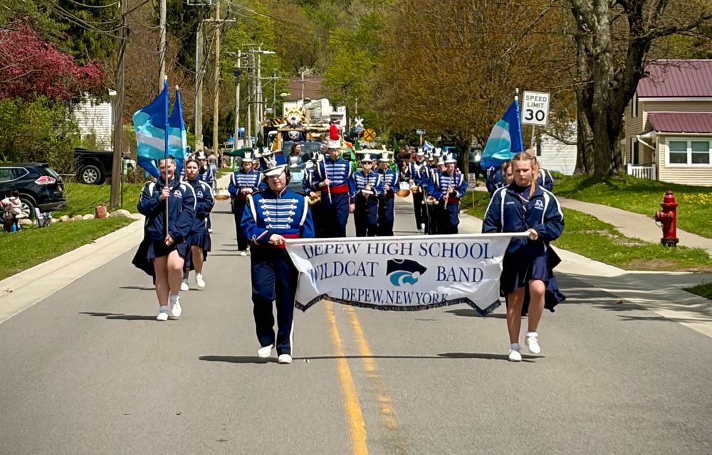 Depew Band walks down street.