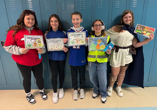 students pose with certificates