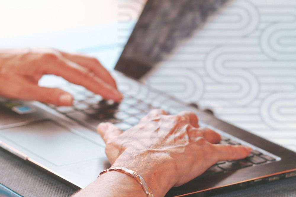 hands typing on keyboard