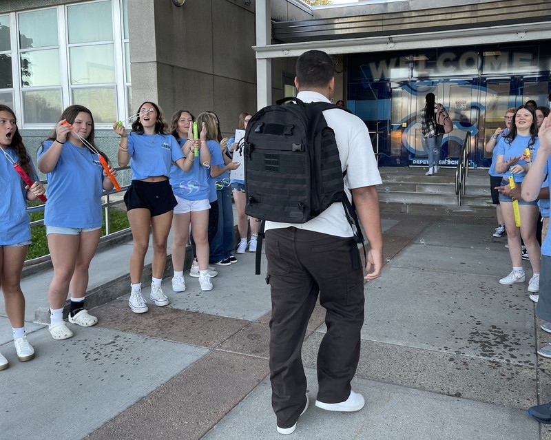 students welcome classmates with cheers and bubbles