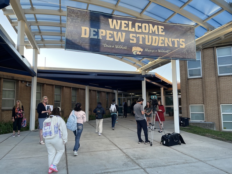 News crew broadcasts Depew first day.