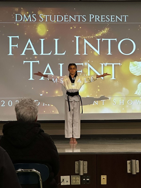 Students stand on stage at talent show