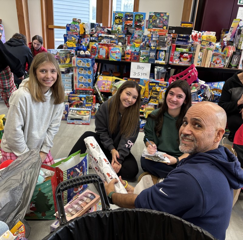 students pose while volunteering at annual day of givin