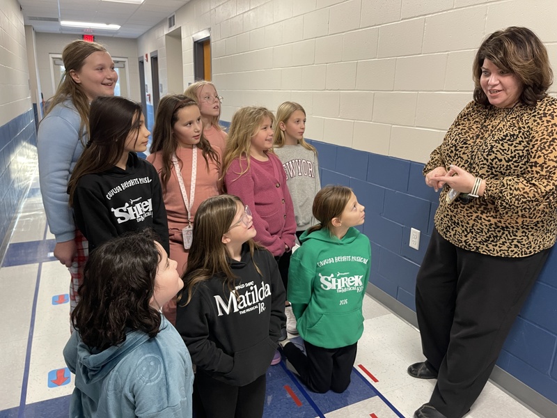 teacher gives students instruction before their next scene