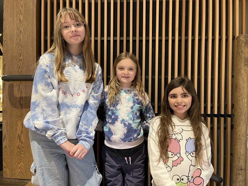 students stand in position on steps for their part in the musical