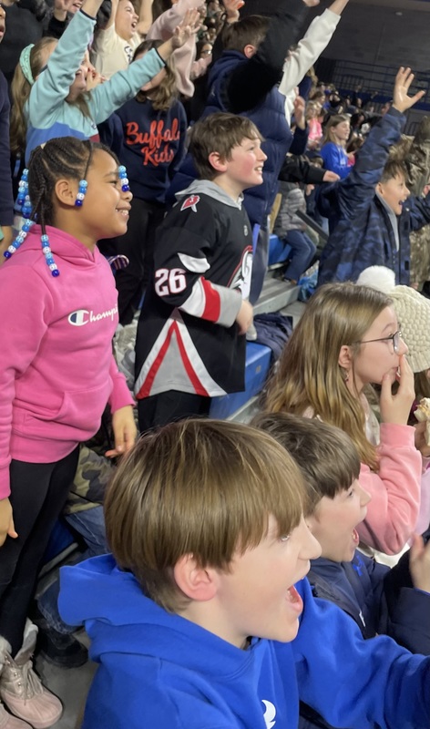 Students have fun at a basketballl game.
