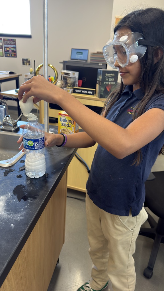 Student holding water bottle and balloon