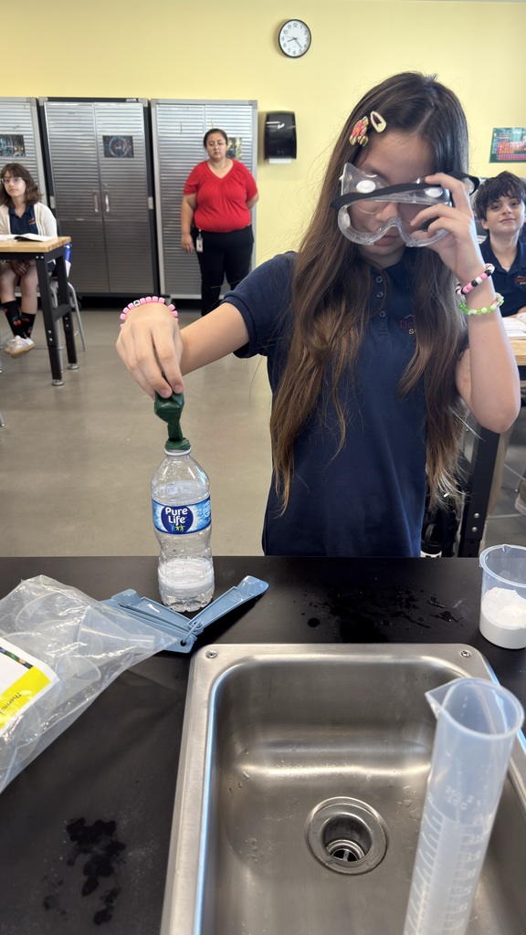 Student holding balloon on top of water bottle