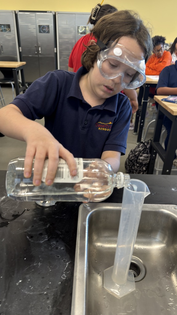 Student pouring water.