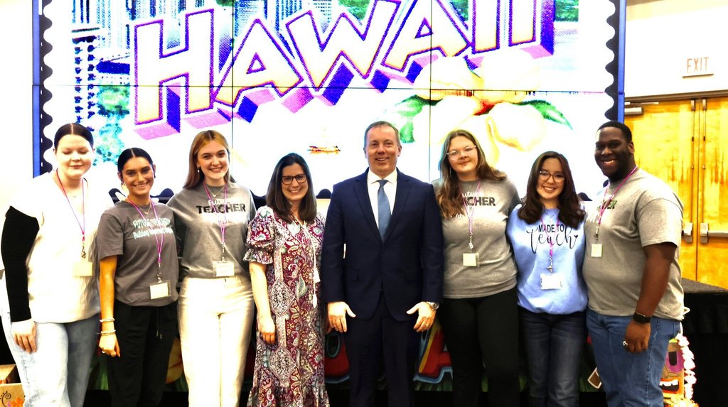 Mr. Uselton smiles with prospective teachers