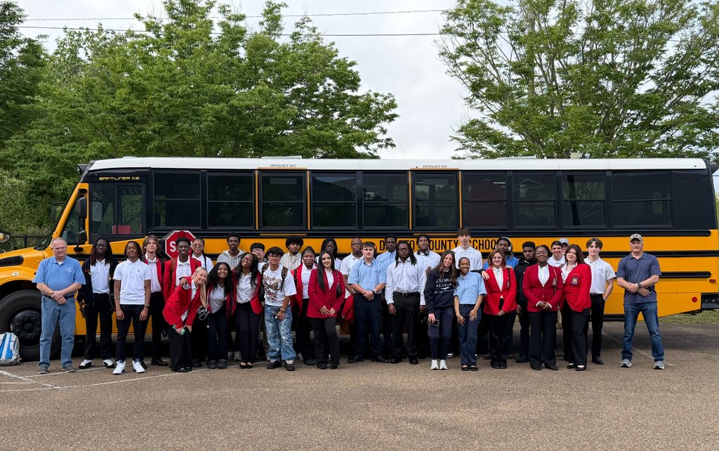 picture of students in front of a bus