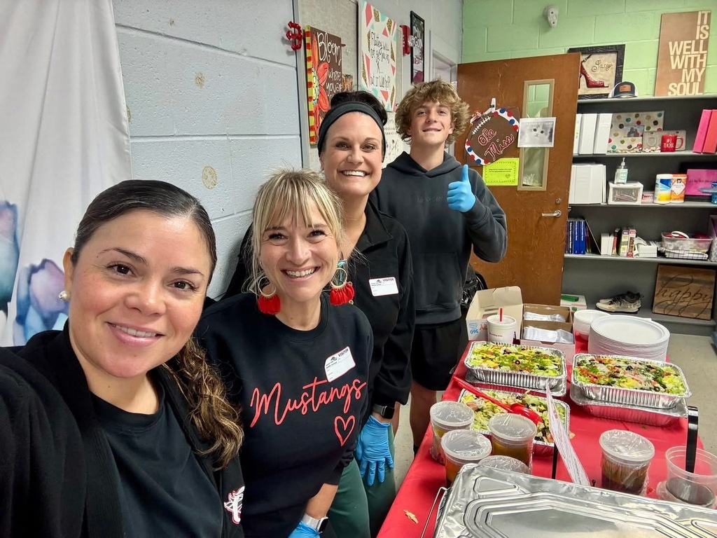 Four smiling people who helped provide and serve lunch to the teachers