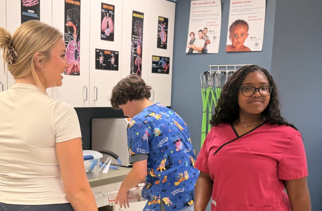 3 students standing in med lab