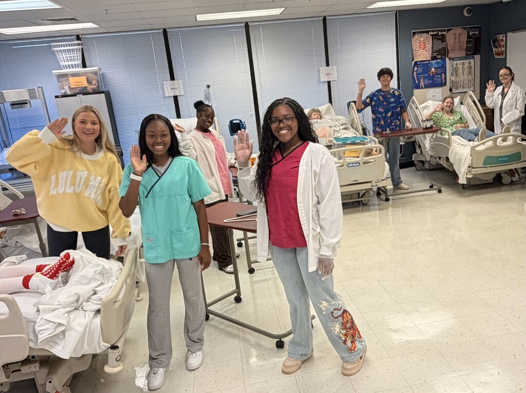 students in the health lab waving at the camera