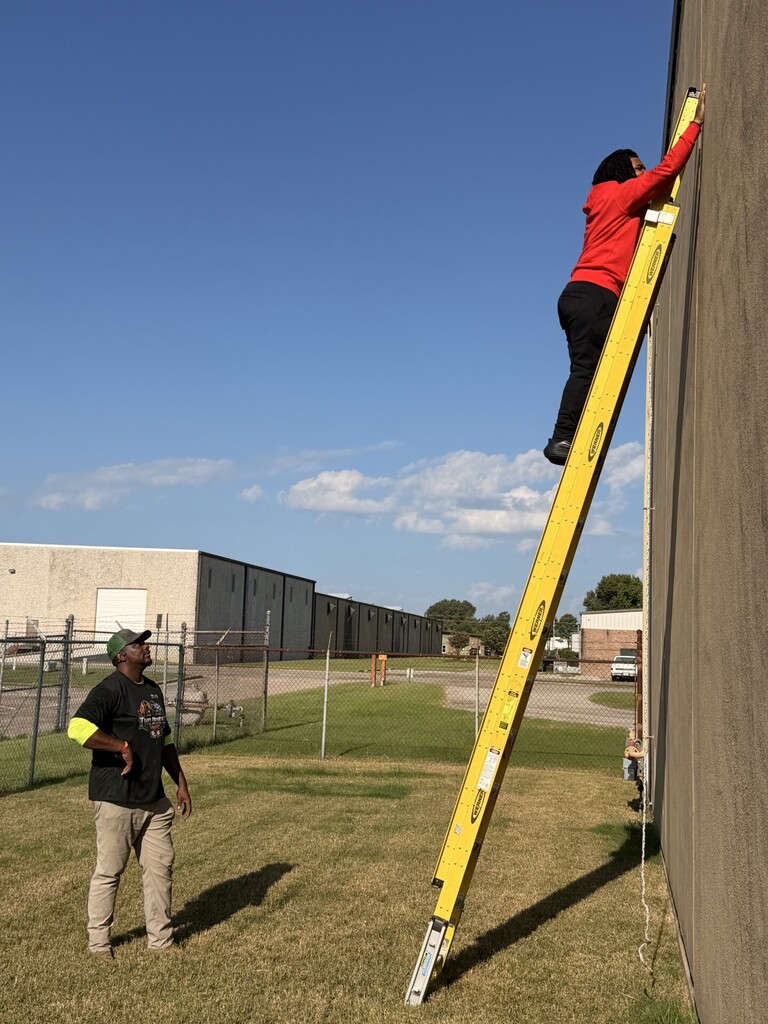 student on extension ladder learning ladder safety