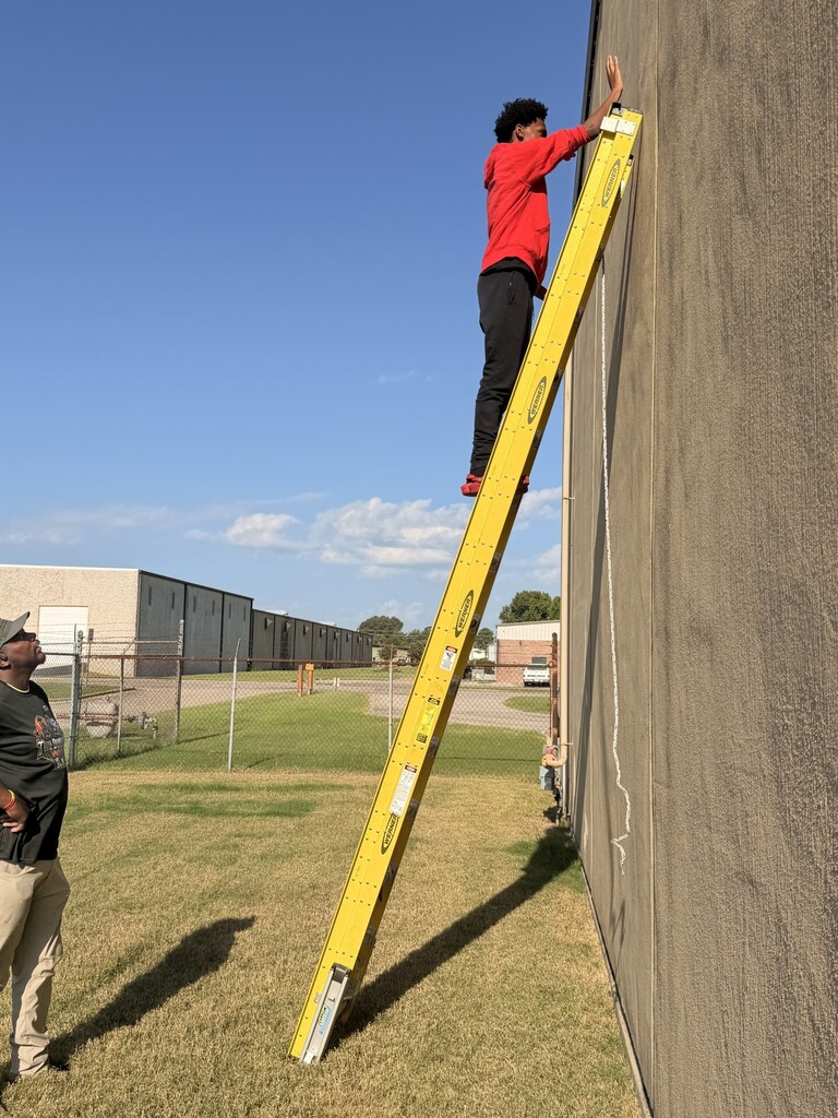 student on extension ladder learning ladder safety