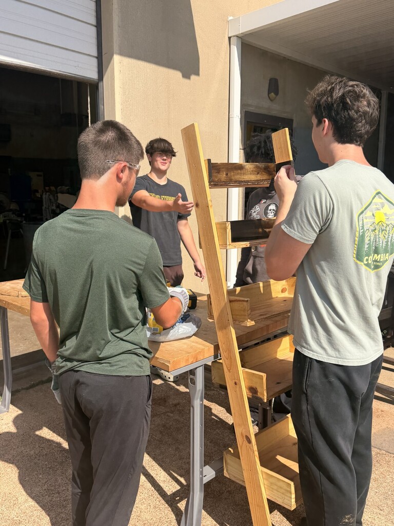 students sanding and staining
