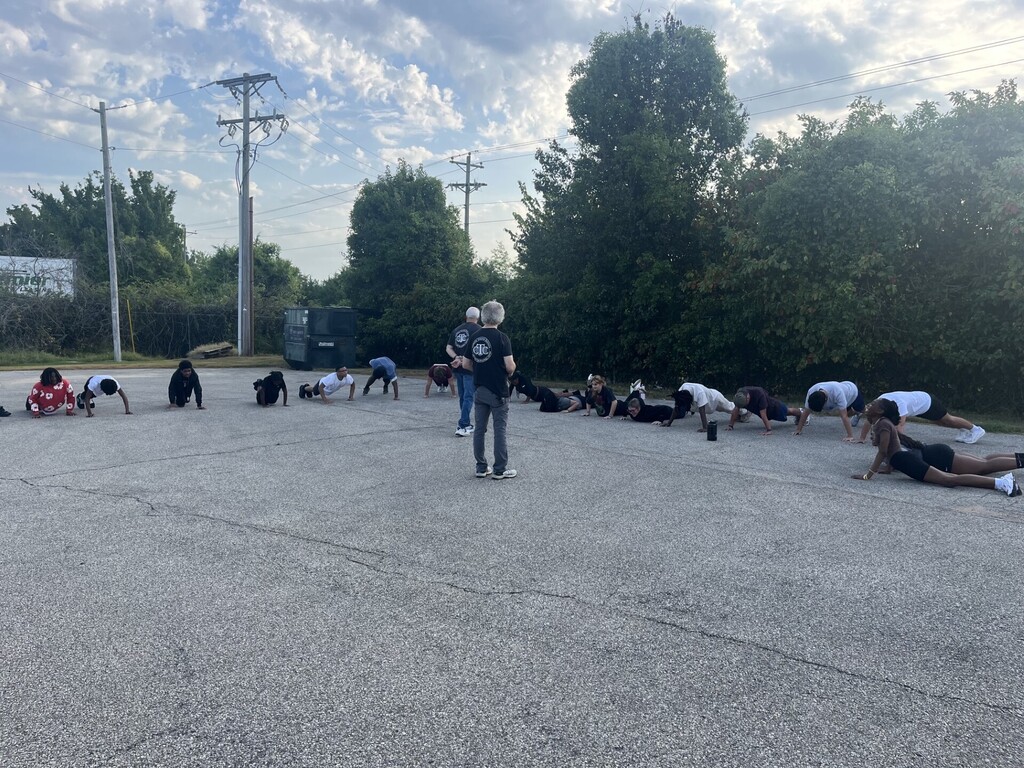 teachers instructing students to do pushups
